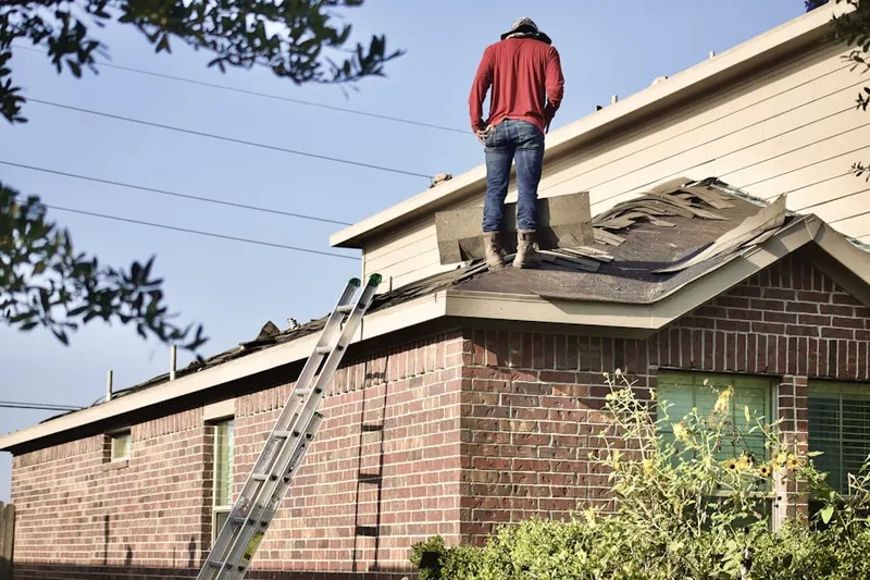 Professional roofer working on a residential roof in Fairfield Beach